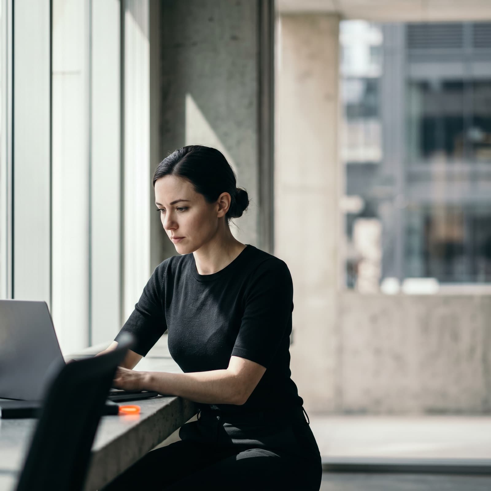 IT specialist working on a laptop in an office